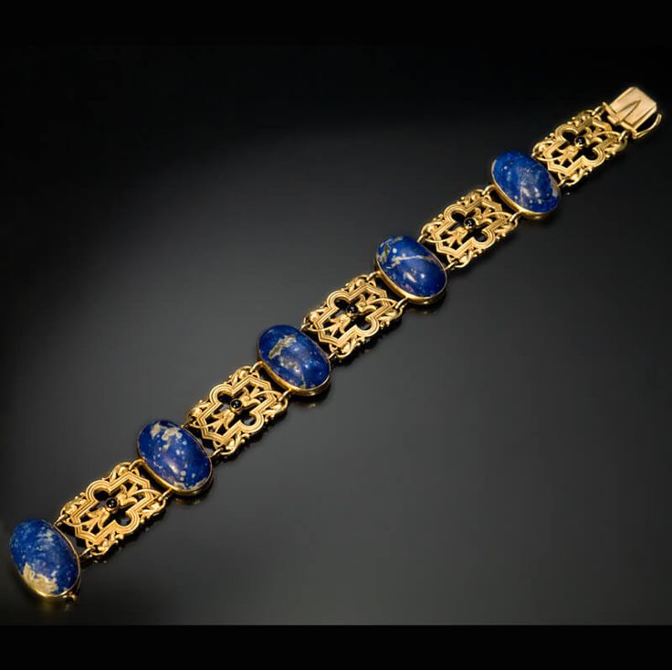 An antique 14K gold bracelet is bezel-set with five lapis lazuli cabochons separ...