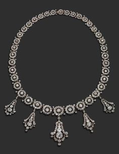 A late Victorian diamond necklace. Formed with graduated circular links, each ce...