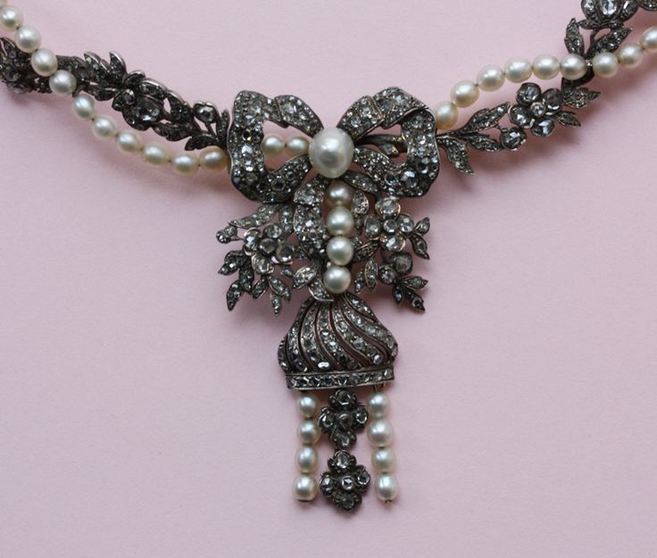 A romantic flower garland necklace with a pendant of a bow, flowers and a tassel...