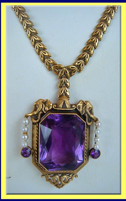 Amethyst, pearl and gold necklace, the pendant decorated with two elephant heads...