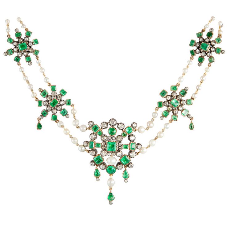 An emerald, diamond, pearl, silver and gold necklace.