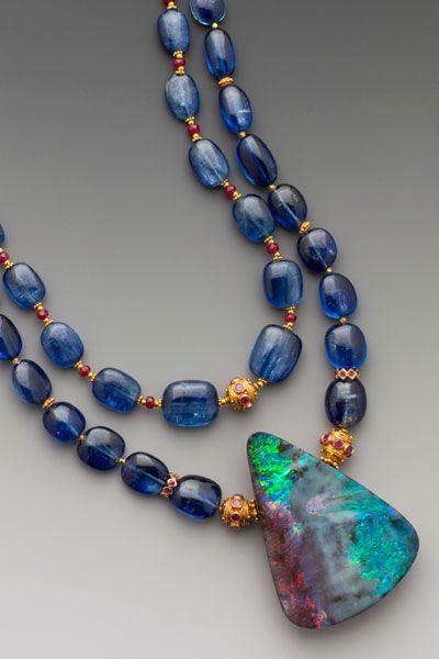 Australian boulder opal withgreens, aquas & smoldering red fire. On two strands ...