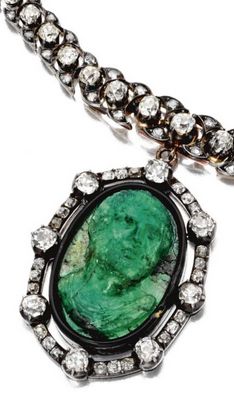 Carved emerald, diamond, silver and gold pendant, on a diamond, silver and gold ...