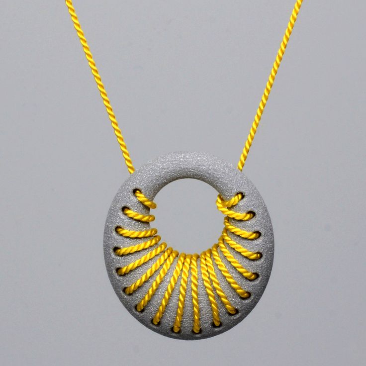 Featured at SXSW 2013: 3D Printed aluminum loop pendant with silk cord woven int...