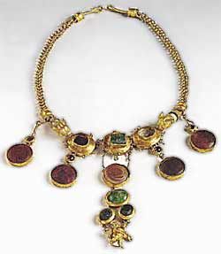 Gold necklace set with garnets and glass paste.