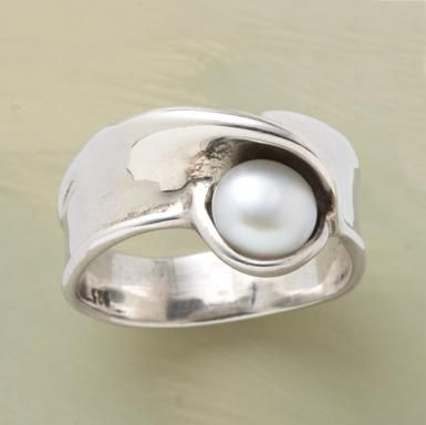 the delicate pearl surrounded in silver.