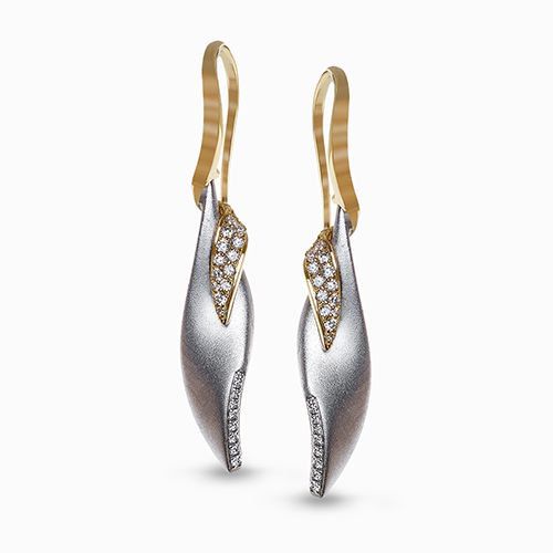 An elegant two-tone design highlights these modern earrings set with .26 ctw of ...